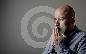 Portrait of depressed sad bald man