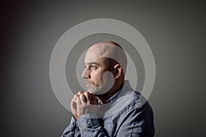 Portrait of depressed sad bald man