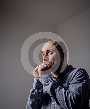 Portrait of depressed sad bald man