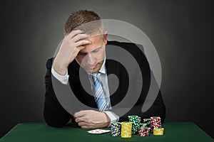 Portrait Of A Depressed Young Male Poker Player