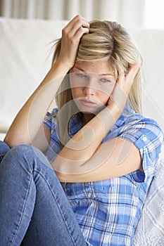 Portrait Of Depressed Young Woman At Home