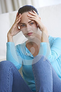 Portrait Of Depressed Young Woman At Home