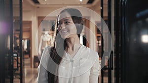 Portrait of designer woman standing in her clothing shop. Small business