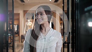 Portrait of designer woman standing in her clothing shop. Small business