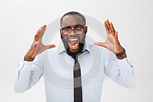 Portrait of desperate annoyed black male screaming in rage and anger tearing his hair out while feeling furious and mad photo