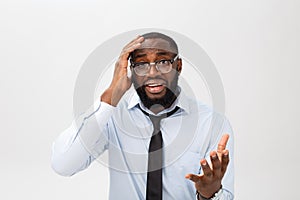 Portrait of desperate annoyed black male screaming in rage and anger tearing his hair out while feeling furious and mad