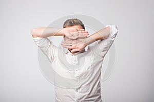 Portrait of desperate sad caucasian man hiding his face