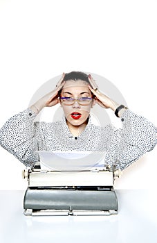 Portrait of a desperate secretary, or a teacher, with a vintage typewriter