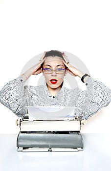 Portrait of a desperate secretary, or a teacher, with a vintage typewriter