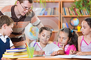 Portrait of diligent schoolkids and their teacher