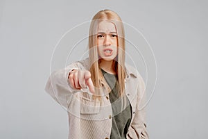 Portrait of disappointed angry young blonde woman frowning wearing casual clothes, pointing index finger at camera, being mad,