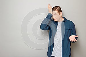 Portrait of disappointed confused man slapping his forehead with hand