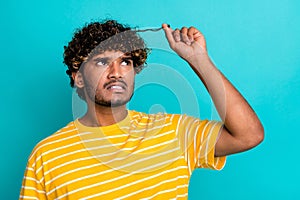 Portrait of disappointed person grin teeth look hand touch split ends hair curls isolated on turquoise color background