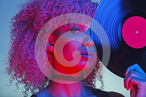 Portrait of a disco woman holding a vinyl with eighties music an