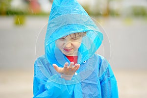 Portrait of a disgruntled child in the rain