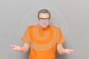 Portrait of disgruntled indignant mature man wearing orange t-shirt