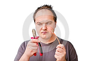 Portrait of disheveled adult male with wire cutters and cut off compute