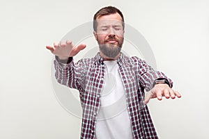 Portrait of disoriented bearded man searching lost road, eyesight problems, blindness. indoor studio shot isolated on white