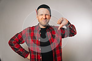 Portrait of displeased caucasian male builder with beard in uniform
