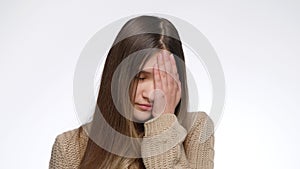 Portrait of displeased girl making facepalm gesture and hitting face with hand