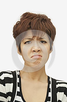 Portrait of displeased short haired young woman, studio shot