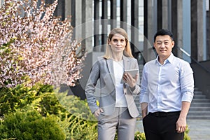 Portrait of diverse business group, asian man and woman in business suits looking at camera