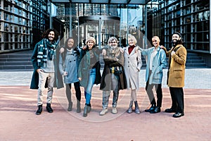 Portrait of diverse business people team posing over corporate office building