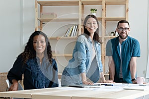 Portrait of diverse colleagues posing together in office