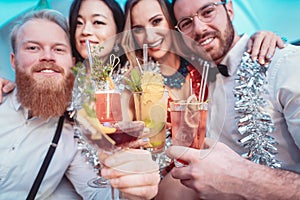 Portrait of diverse friends holding cocktails in hands