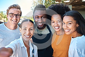 Portrait of diverse friends taking a selfie, bonding and enjoying their freedom outdoors together. Young group having