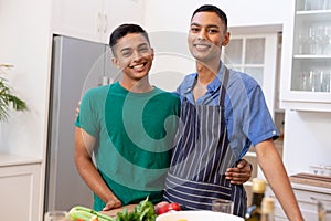 Portrait of diverse gay male couple spending time embracing and smiling