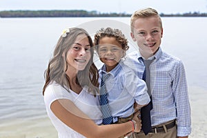 Portrait of diverse group of beautiful children in formal dress. Cute smiling faces of hispanic girl, African American boy and cau