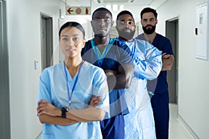 Portrait of diverse group of healthcare workers standing in line in hospital corridor