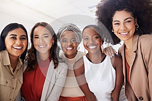 Portrait of a diverse group of smiling ethnic business women standing together in the office. Ambitious happy confident