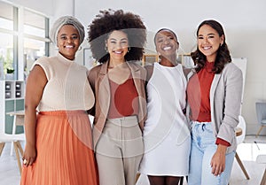 Portrait of a diverse group of smiling ethnic business women standing together in the office. Ambitious happy confident