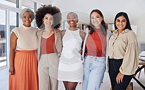 Portrait of a diverse group of smiling ethnic business women standing together in the office. Ambitious happy confident