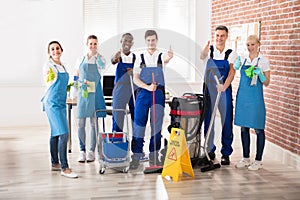 Portrait Of Diverse Janitors Showing Thumb Up Sign