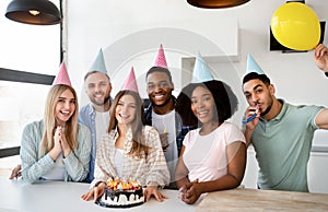 Portrait of diverse young friends celebrating birthday together at home