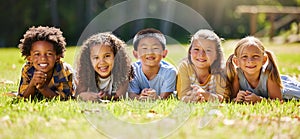 Portrait, diversity and children on grass, friends and summer break with smile, chilling and relax. Face, kids and young photo