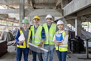 Portrait of the diversity team of engineer, architect, worker and safety manager smiling together at the construction site wearing
