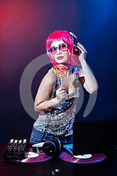 Portrait dj headphone vinyl disk candy plays equipment summer disco girl party retro vintage pink red desk mixer glamour glasses y