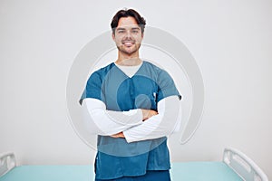 Portrait, doctor and arms crossed for smile in space for health, treatment or wellness. Happy man, nurse and scrubs for