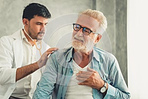 Portrait of doctor is examining physical symptom of senior patient in examination room, Healthcare and occupational concept photo