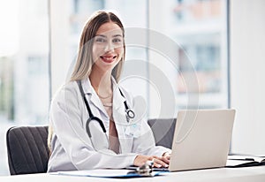 Portrait, doctor and laptop with a woman at work in a hospital for healthcare, consulting or trust. Medical, research