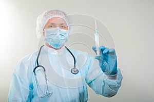 Portrait of a doctor man in a medical mask. There is a stethoscope on the doctor`s neck. During a pandemic, remedies are essentia