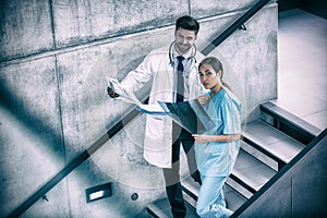 Portrait of doctor and nurse holding medical reports