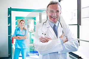 Portrait of doctor and nurse standing with arms crossed