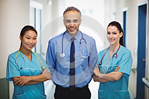 Portrait of doctor and nurses standing with arms crossed