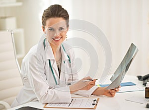 Portrait of doctor woman holding fluorography photo