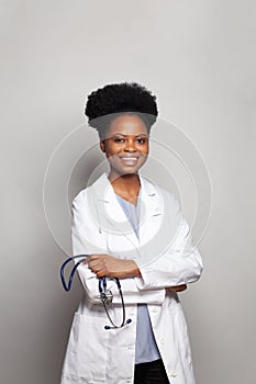 Portrait of doctor woman holding stethoscope and looking at camera on white background